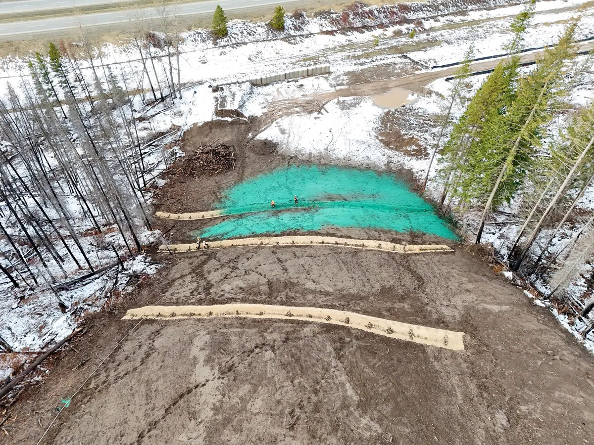 Drone view of hydroseeded slope behind coir silt-log berms