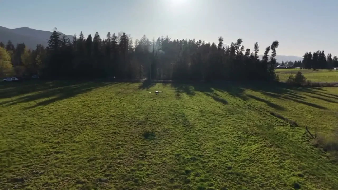 Aerial view of a Raincoast seeding drone over a green field on Vancouver Island