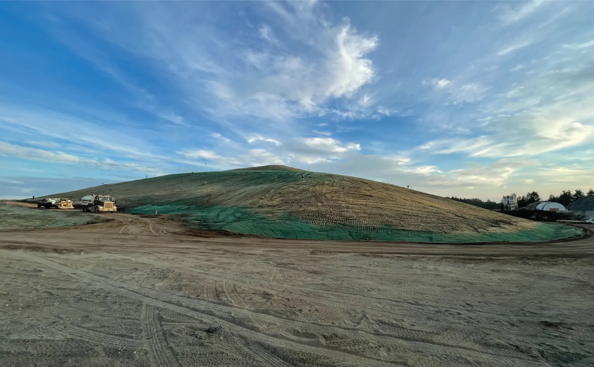Completed earthwork mound capped with hydroseed